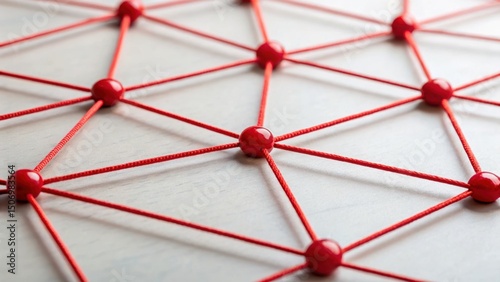 Close-up of red thread linking compliance nodes, representing connected tax process, legal structure, and regulatory coordination in finance