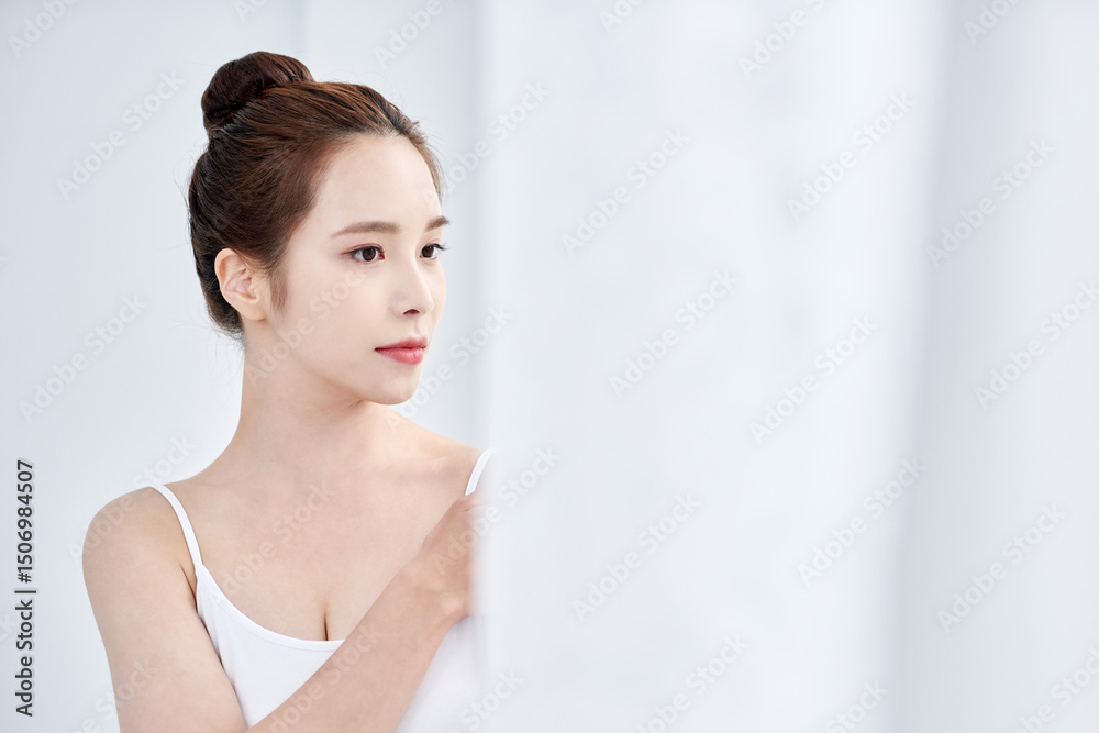 Young Asian Woman in White Tank Top with Elegant Updo, Minimalist Soft Light Portrait Young Asian Woman in White Tank Top with Elegant Updo, Minimalist Soft Light Portrait