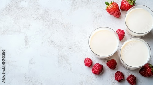 Three elegant glasses filled with creamy smoothies, surrounded by fresh raspberries and strawberries, embodying vibrant flavors and nutritional goodness in a visually captivating arrangement. photo