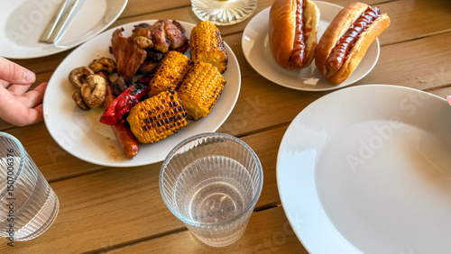 Summertime feast with grilled maize and sizzling sausages, echoing backyard juneteenth celebrations and outdoor picnics, multicultural flavors unite