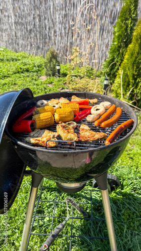 Sizzling grill symphony of corn, peppers, and sausages evokes midsummer picnics and eccentricity of Garden Gnome Day celebrations