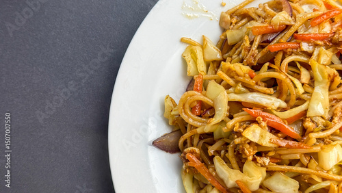 Stir-fried noodle medley exudes umami, perfect for Lunar New Year feasts, bursting with colorful crunch and savory whispers