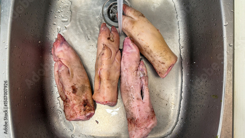 Fresh pig trotters soak serenely, echoing rustic autumn cuisine rituals and All Souls' Day culinary preparations