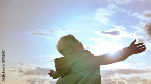 Radiant Daydream: Boy Soaking Up Sunlight and Looking Up in Fascination