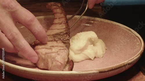 4K. The cook puts the meat with mashed potatoes in a plate.