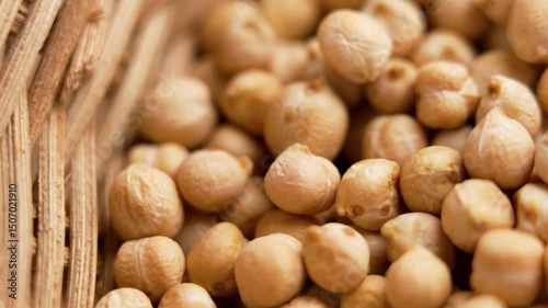 Dried protein ingredient chickpeas in rattan bowl close-up. Healthy food. Legume family. Top view. Rotation