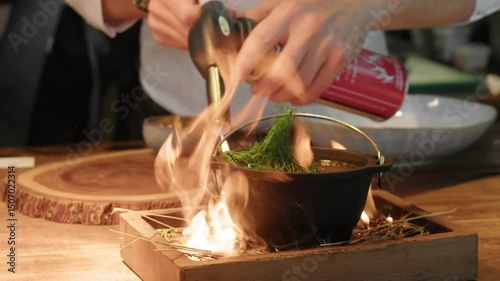 4K. Close-up of the cook heating the soup with a burner