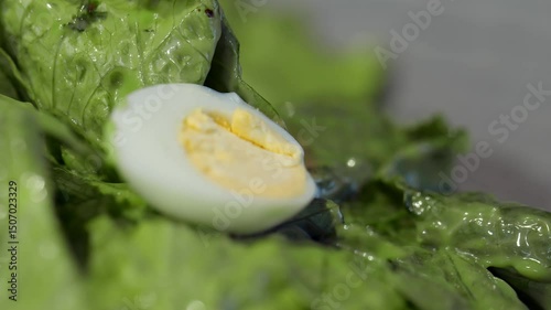 4K. Fresh salad with fresh lettuce leaves, boiled eggs in a bowl.