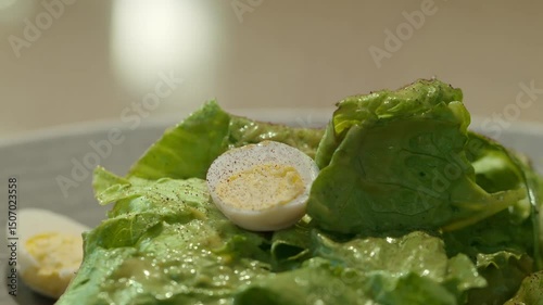 4K. Fresh salad with fresh lettuce leaves, boiled eggs in a bowl.
