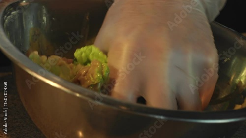 4K. The cook mixes a fresh salad with fresh lettuce leaves, boiled eggs in a bowl.