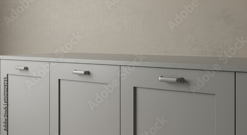 Matte-finished light gray cabinetry with seamless handles and clean vertical lines set against a warm linen backdrop.