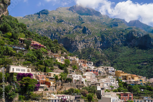 Wallpaper Mural Explore the stunning cliffside village of Positano in Amalfi Coast Italy, featuring colorful buildings nestled against the dramatic mountains and lush greenery. Torontodigital.ca