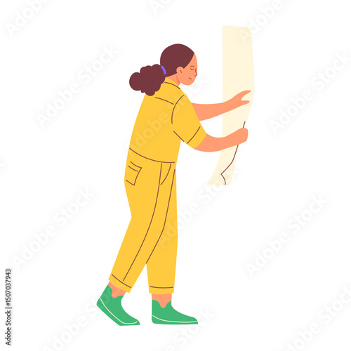 A girl glues wallpaper. Repair concept
