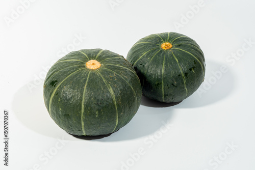 Beibei pumpkin, a small dark green squash from Japan, is favored for its sweet, nutty taste and smooth, chestnut-like texture when cooked. Its thin skin is edible, making it versatile for roasting photo