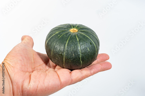 Beibei pumpkin, a small dark green squash from Japan, is favored for its sweet, nutty taste and smooth, chestnut-like texture when cooked. Its thin skin is edible, making it versatile for roasting photo