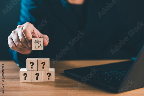 Hand places AI Artificial Intelligence cube on question marks cubes. A visual concept for integrating AI into future business and marketing strategies, driving innovative solutions and business growth