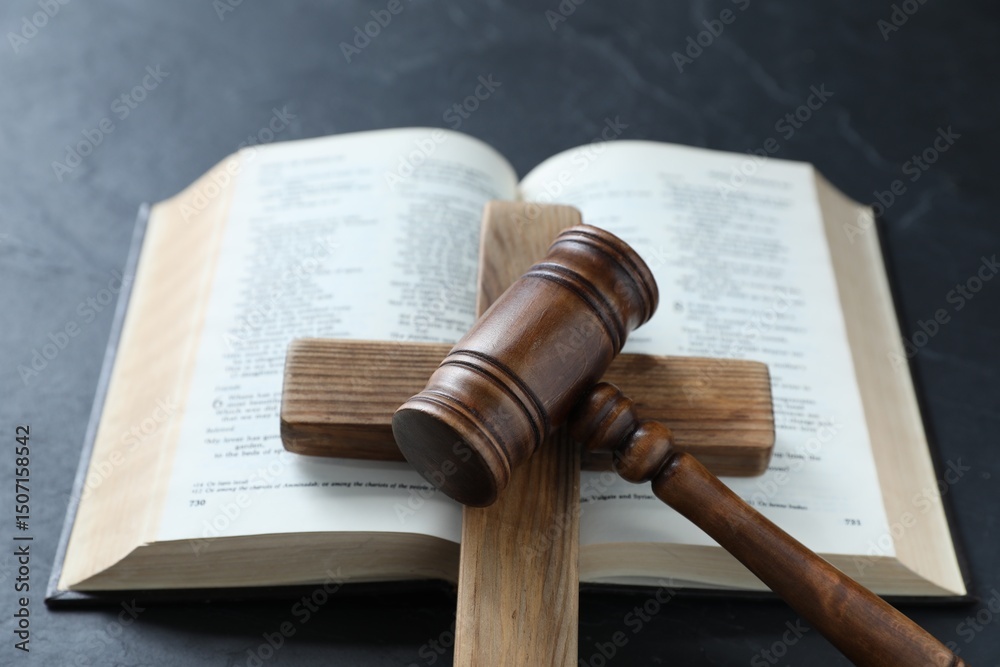Fototapeta premium Judge's gavel, Bible and wooden cross on black table, above view