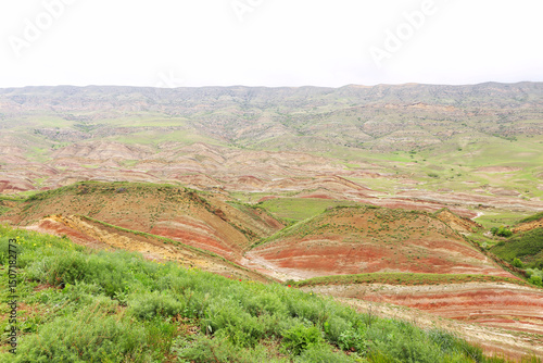 Colorful spectacular panoramic view of rainbow mountains hills in Georgia. Striped desert of Mravaltskaro mountains at the border of Georgia and Azerbaijan. Famous tourist place