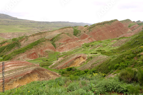 Colorful spectacular panoramic view of rainbow mountains hills in Georgia. Striped desert of Mravaltskaro mountains at the border of Georgia and Azerbaijan. Famous tourist place