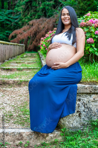 Pregnant Woman Sitting Peacefully in Garden Path