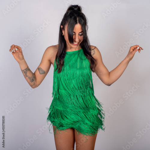 Smiling Woman Dancing in Green Fringe Dress on White Background