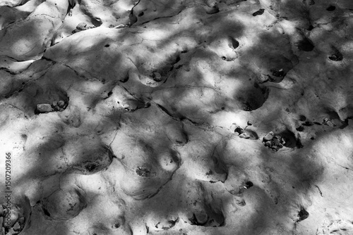 Dry rock formation on riverbed in black and white