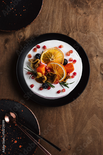 Fruit cake on dark wooden background.