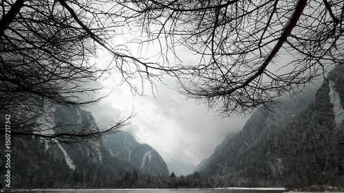 Natural scenery, deciduous trees, lake surrounded by snow-capped mountains at Bipenggou national park, It is an important eco-tourism demonstration area in Sichuan Province, China. 