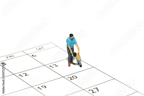 Miniature people toy figure photography. A father and son walking above calendar. Isolated white background