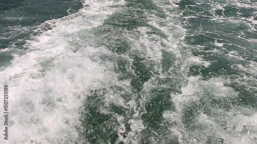 Water wake behind a ship on the open sea, slow motion