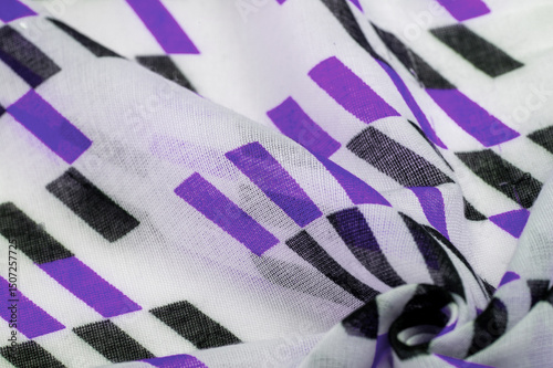 Texture. Background. Template. White silk fabric with purple and black geometric rhombus shapes. violet, violaceous