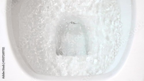 The flushing process in the toilet bowl, slow motion