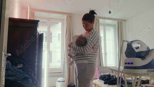 Mother breastfeeding her baby while standing in a peaceful home environment, quiet nurturing moment, intimate family connection, motherly care and affection indoors