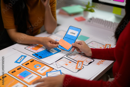 Obraz na płótnie User experience designers working on a new mobile application using paper prototypes