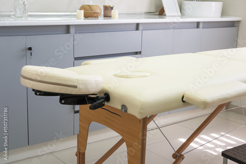 Massage table with face hole in empty therapy room