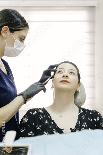 Doctor injecting woman's face during professional cosmetic treatment