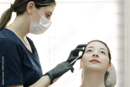 Calm patient receiving facial injections in modern aesthetic clinic