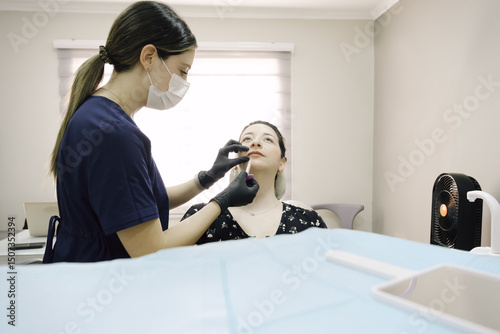 Woman undergoing anti-aging injections by skincare specialist