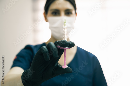 Doctor preparing hyaluronic acid injection in aesthetic clinic