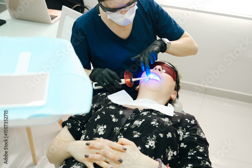 Dental specialist working with tools during oral exam