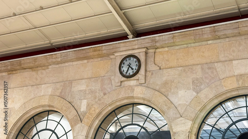 Antique railway clock echoes time's whispers, stone arches hold secrets of bygone journeys, resonating with Railway Heritage Day nostalgia photo