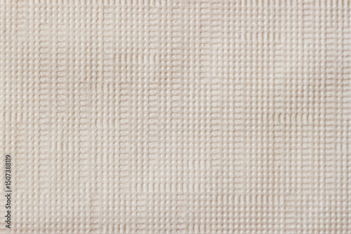 Closeup of beige fabric texture with subtle grid pattern and soft fiber structure. Concept of natural textile background, minimal design, woven surface detail, minimal natural texture