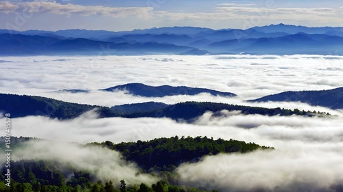 Misty morning mountain landscape with reflections on a calm lake under a vast sky