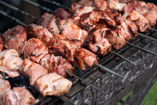 Obraz na płótnie Traditional shashlik on skewers over charcoal w salonie