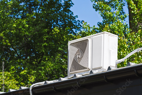 Rooftop Heat Pump Air Conditioner with Green Foliage Background