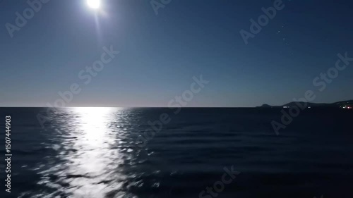 A mesmerizingly enchanting full moon night over a serene sea, where the moonlight dances on gentle waves and reflects a shimmering path towards the horizon.