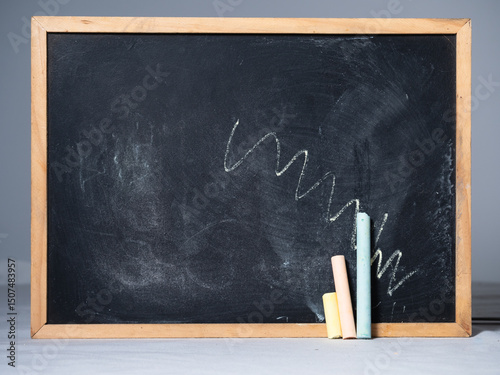 Pastel chalks on chalkboard