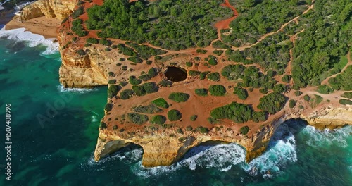 Aerial view of Benagil Cave, viewed through the circular cliff-top hole Algarve, Portugal