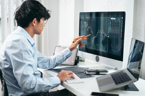 Businessman investor working with computer, tablet and analyzing graph stock market trading planning with chart data financial investment planning