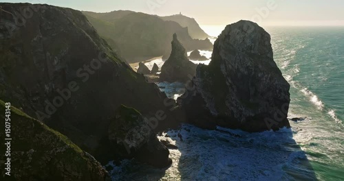 Aerial view Ursa beach Atlantic coastal surf with foamy waves crashing over big rocky cliffs. Portugal